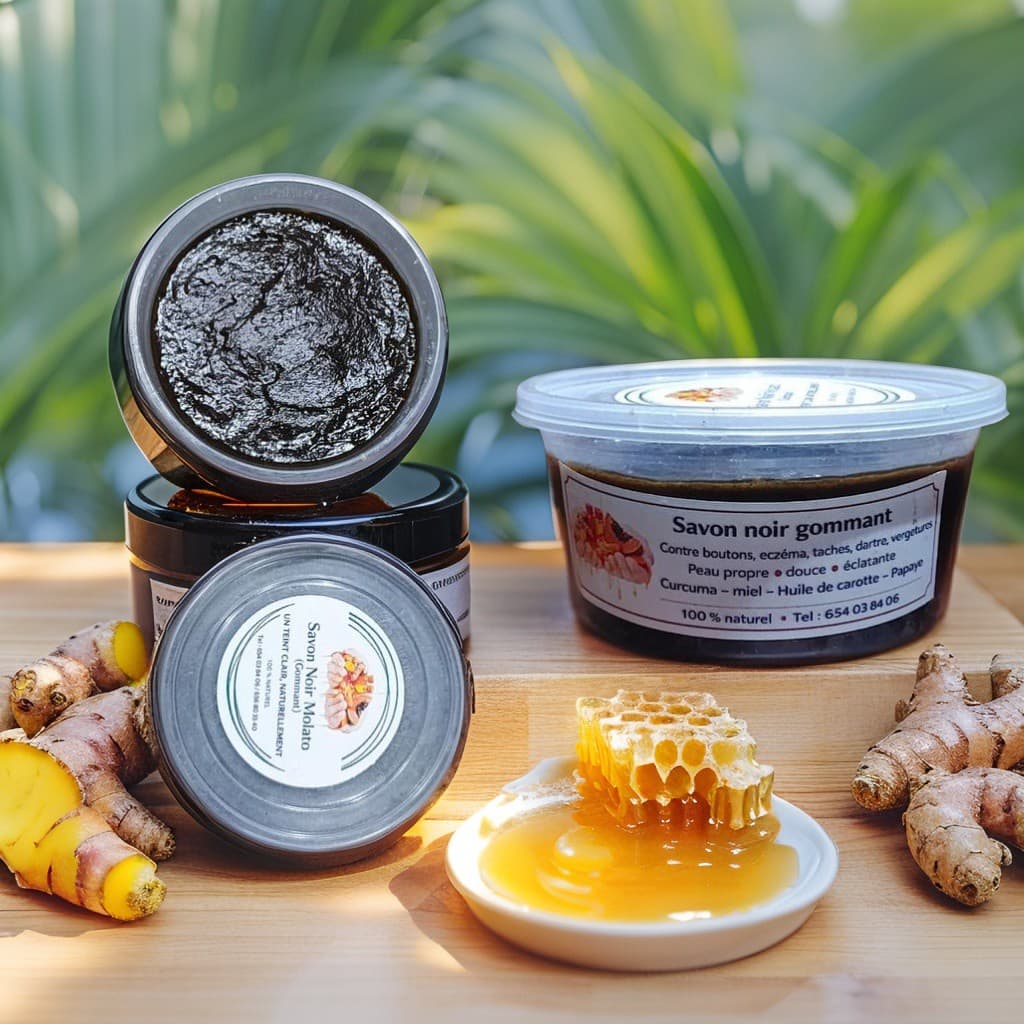 Black exfoliating soap jars with turmeric roots and a honeycomb dripping with honey.
